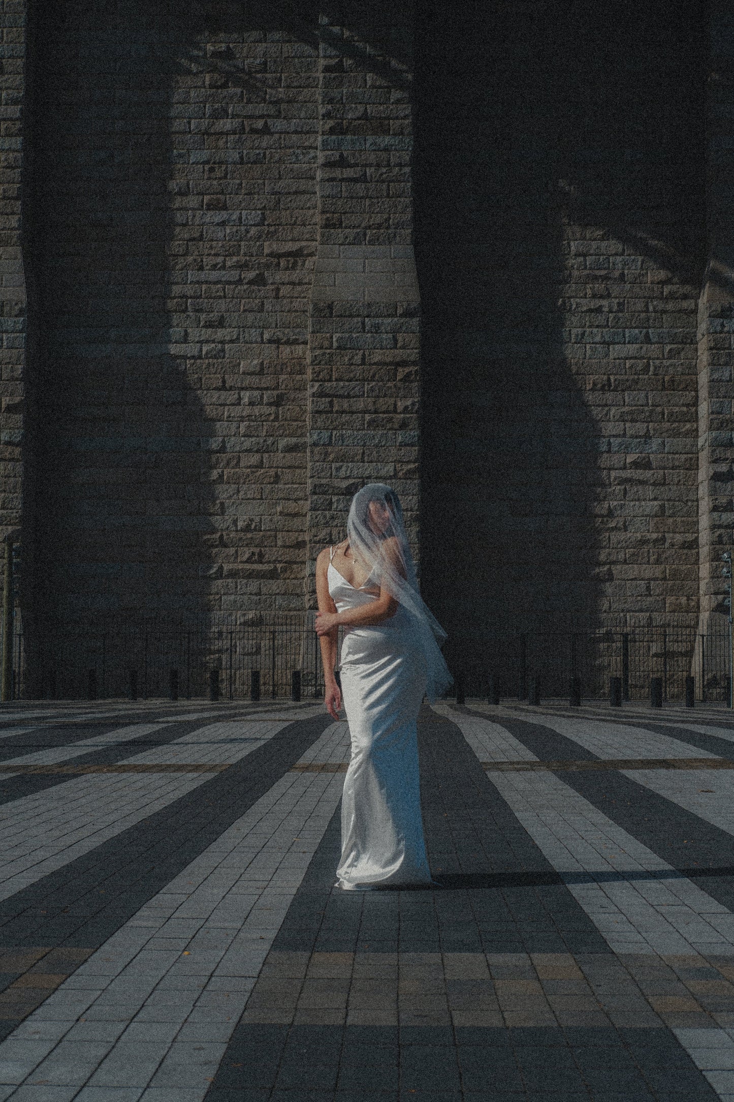 romantic drop two layer wedding veil in Swiss dotted mesh and wearing simple column wedding dress