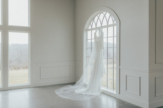 gorgeous wedding venue with windows and clean timeless mikado gown and long cathedral bridal veil with custom embroidered last name