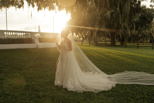 extra long bridal veil cascade style in light ivory for long flowy wedding dress at sunset