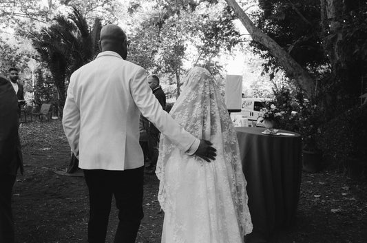 bride in Spanish style floor length wedding veil with small embroidered flowers