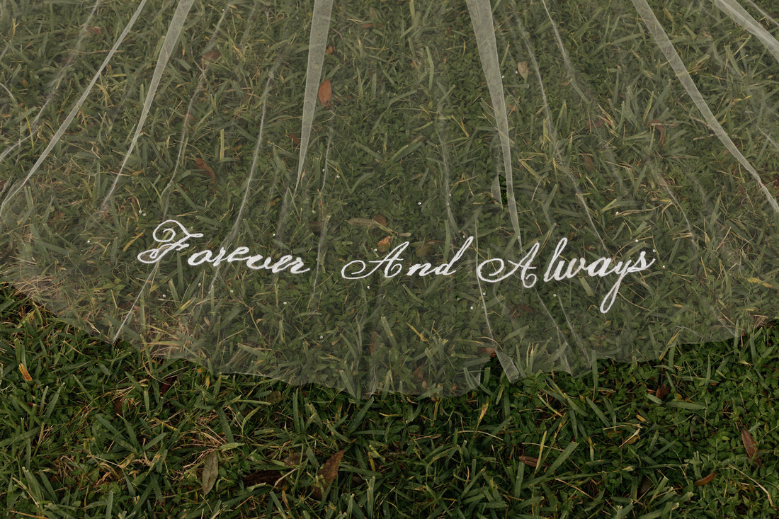 long embroidered forever and always script wedding veil on grass with scattered beading