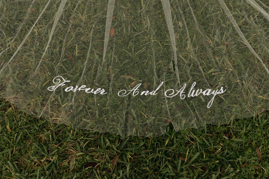 long embroidered forever and always script wedding veil on grass with scattered beading