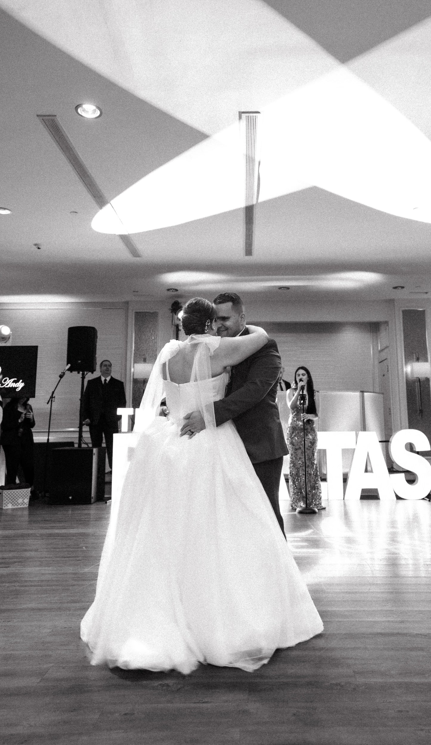 wedding reception with large chiffon bridal bow set on bride's shoulders