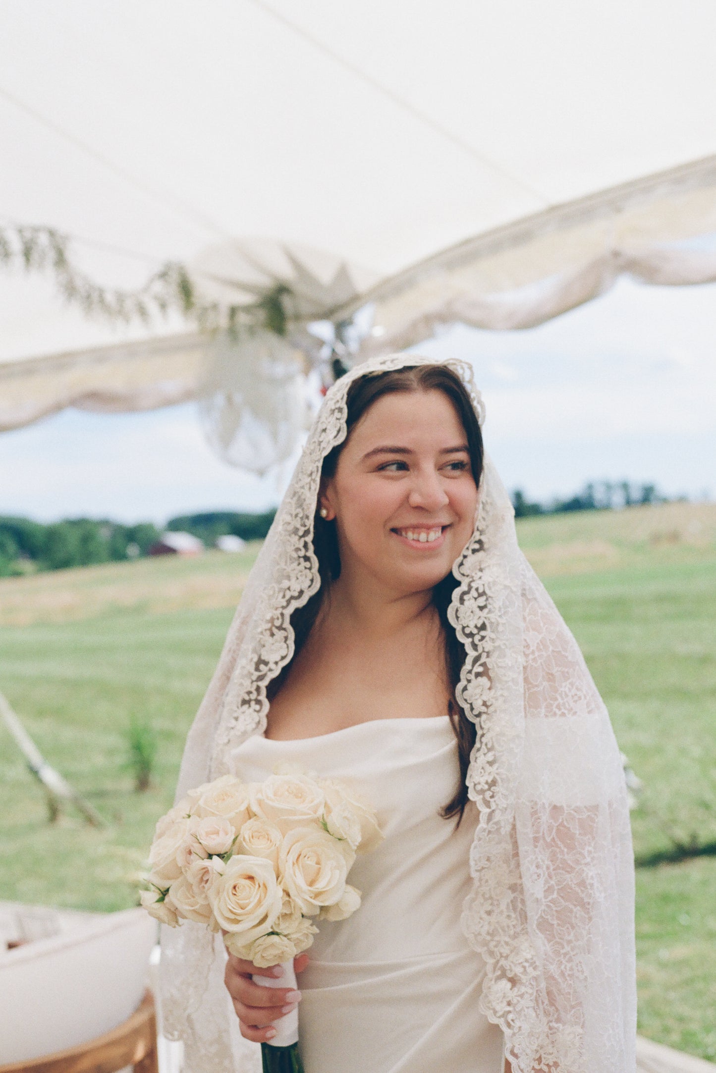 romantic vintage inspired ivory full lace mantilla wedding veil on bride holding white rose bouquet
