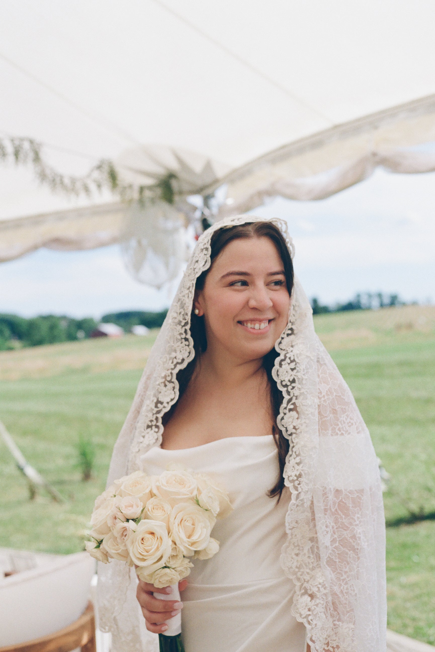 romantic vintage inspired ivory full lace mantilla wedding veil on bride holding white rose bouquet