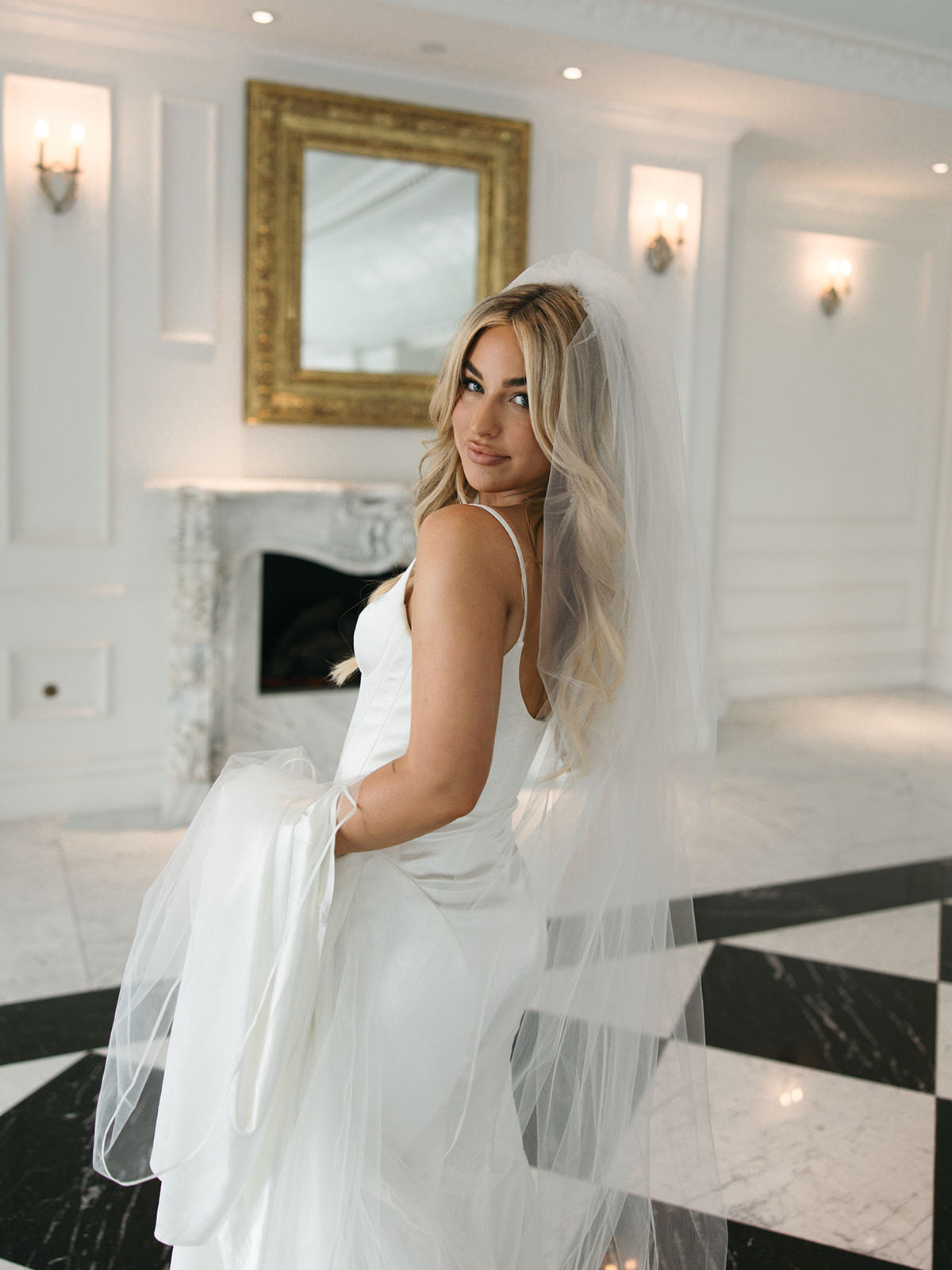 long royal bridal veil with satin trim and blusher in bride's wavy downdo hair