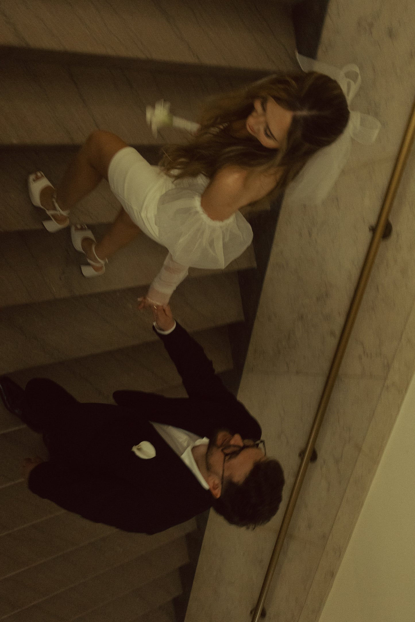 post wedding exit with bride in white structured hair bow in downdo natural hair