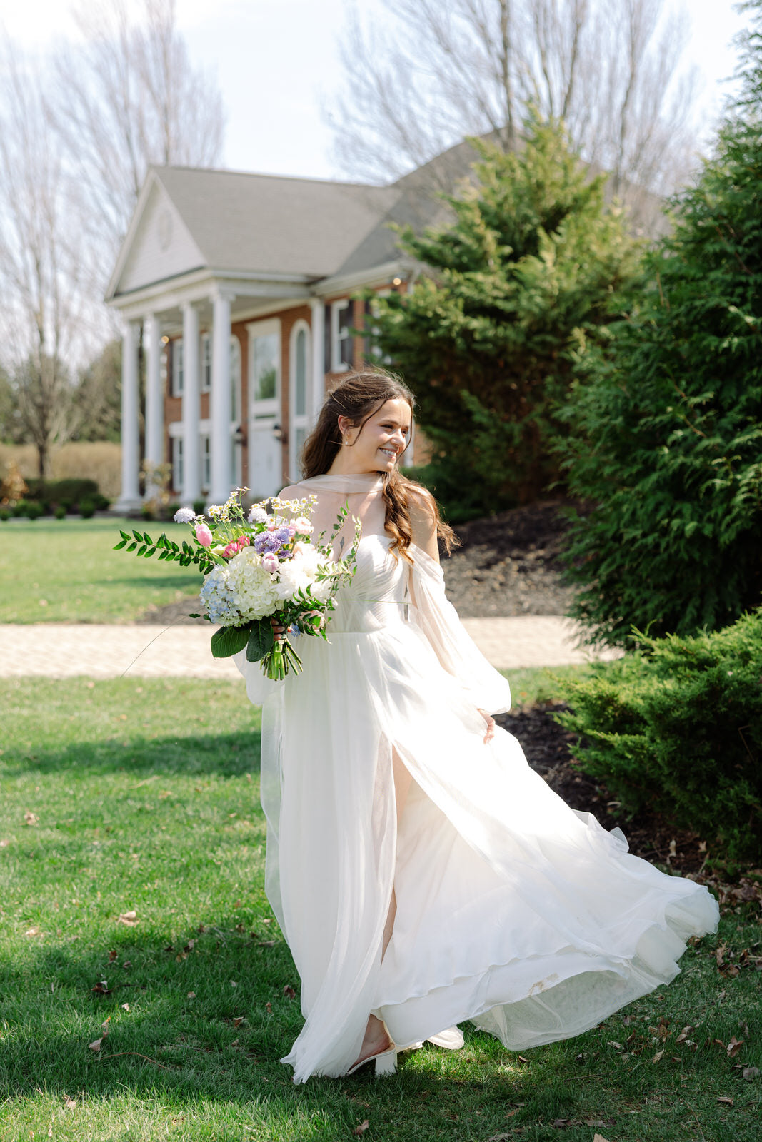 Woman in a white  chiffon off shoulderwedding dress wearing narrow tulle bridal scarf for neck