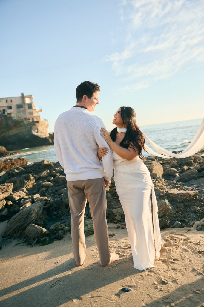beach engagement photo shoot with hispanic bride in long skinny silk satin scarf and strapless gown
