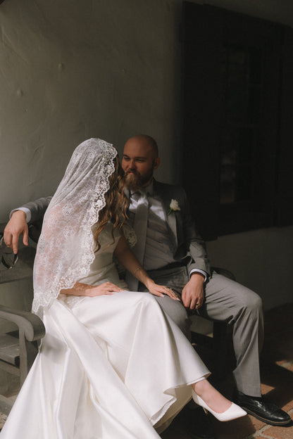 bride and groom portrait with floral lace ivory wedding veil mantilla style