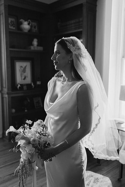 Black and white photo of a bride holding a bouquet wearing bespoke one of a kind vintage Juliet cap wedding veil