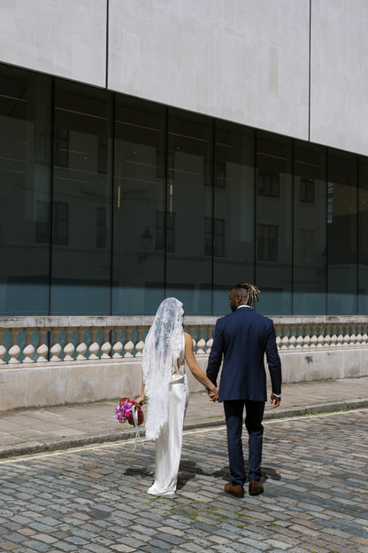 small city wedding elopement with chic modern bride wearing romantic lace mantilla vale