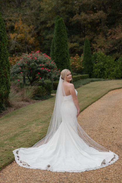 long elegant cathedral bridal veil with eyelash lace trim on bride in strapless gown for estate wedding