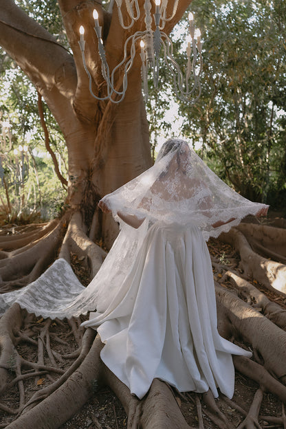 Italy lace cathedral veil Basque waist bride under large tree with chandelier
