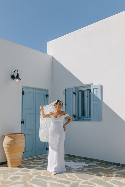 stunning greek wedding with bride in knee length mantilla bridal veil and greek white houses in background