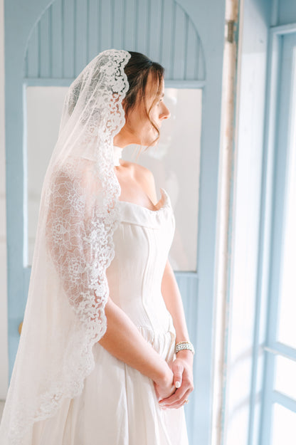 New Mexico bride in drop waist gown and mantilla fingertip lace veil and neck scarf