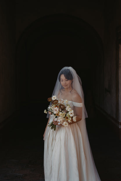 romantic vintage bridal gown with exaggerated hips and custom silk bridal veil with blusher over updo