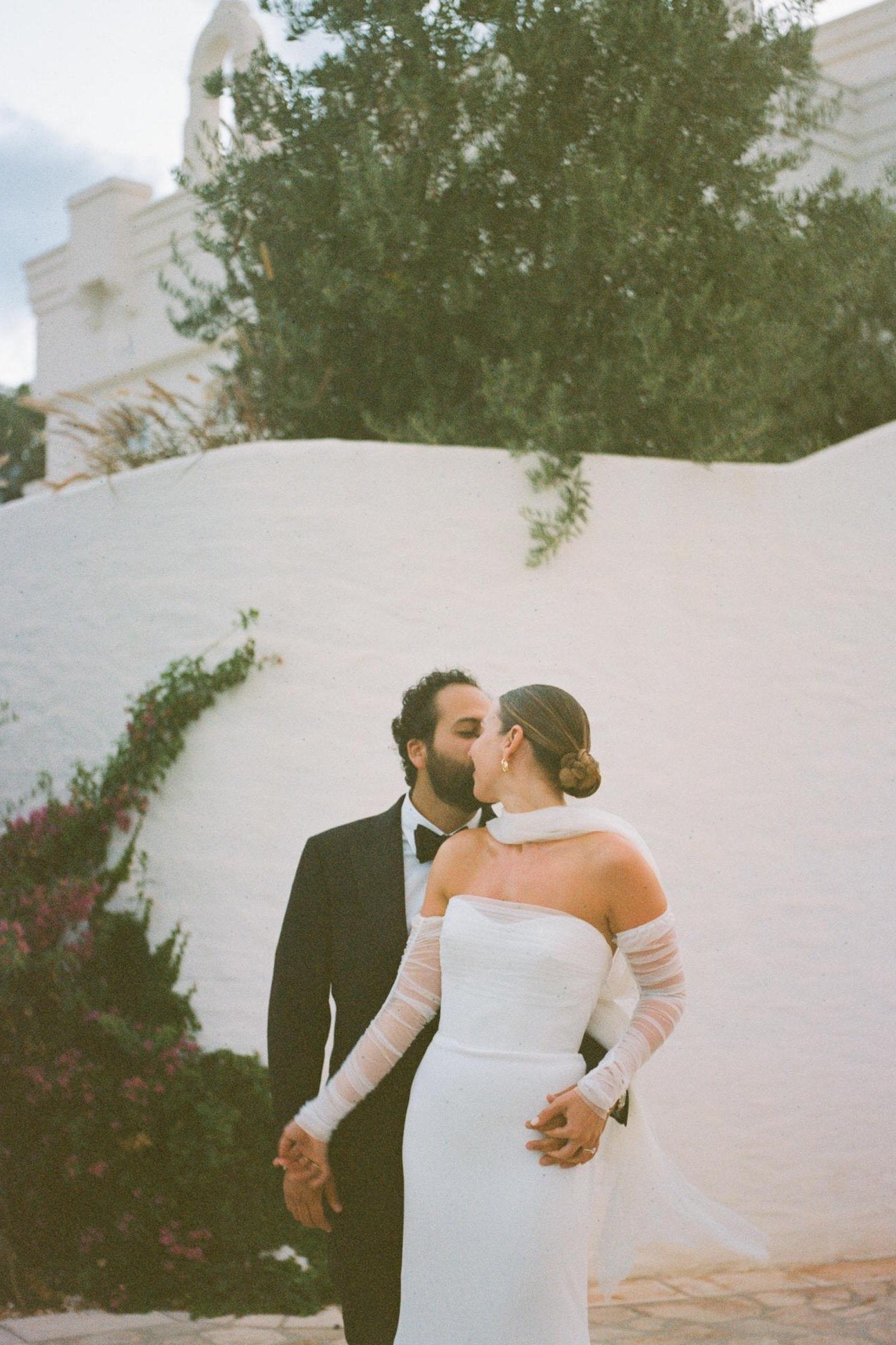 overseas wedding with chic bride in tulle glove set and light ivory neck scarf for strapless sheath dress