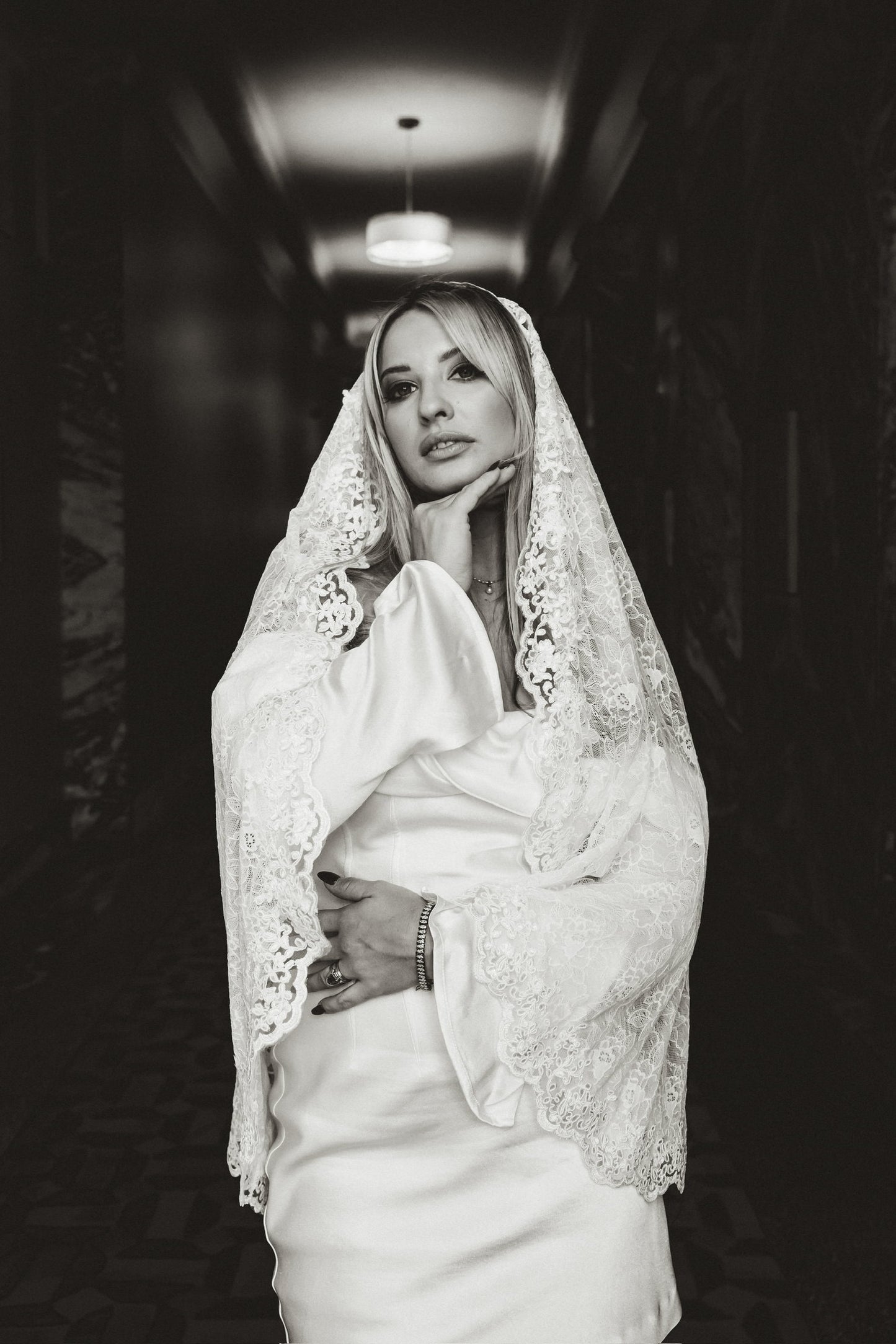 romantic lace wedding veil on blonde bride in long sleeve dress for hotel wedding