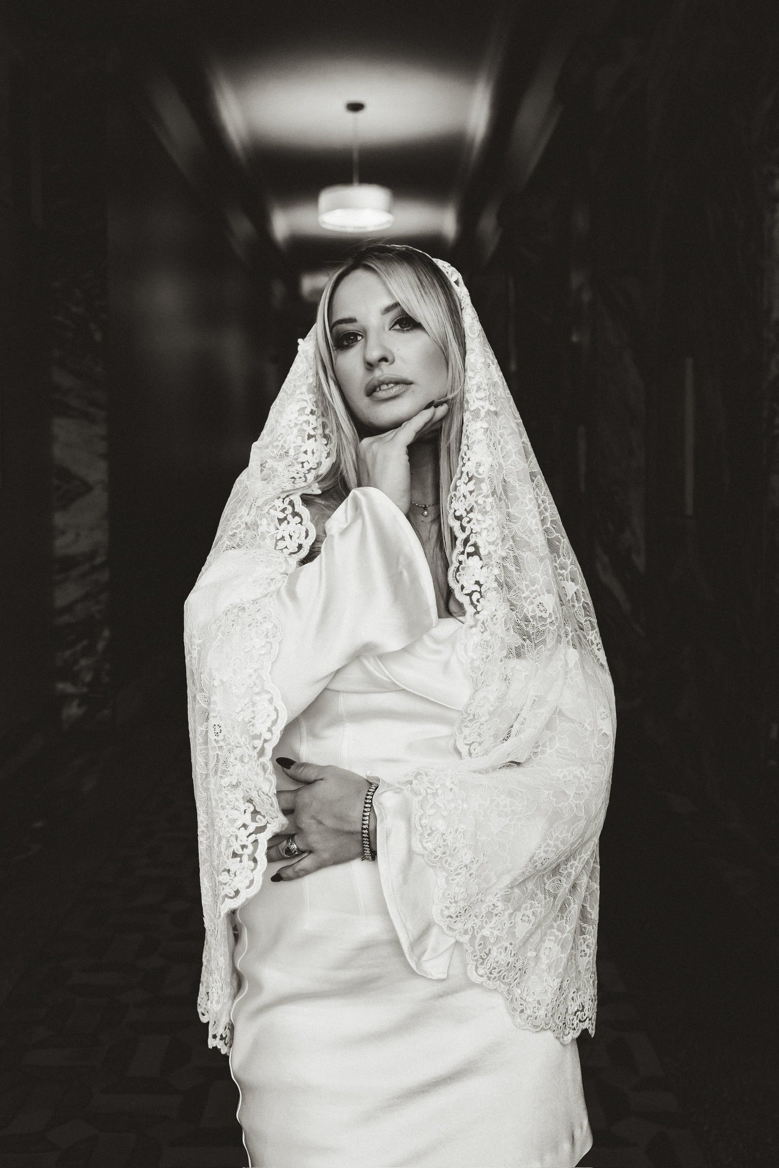 romantic lace wedding veil on blonde bride in long sleeve dress for hotel wedding