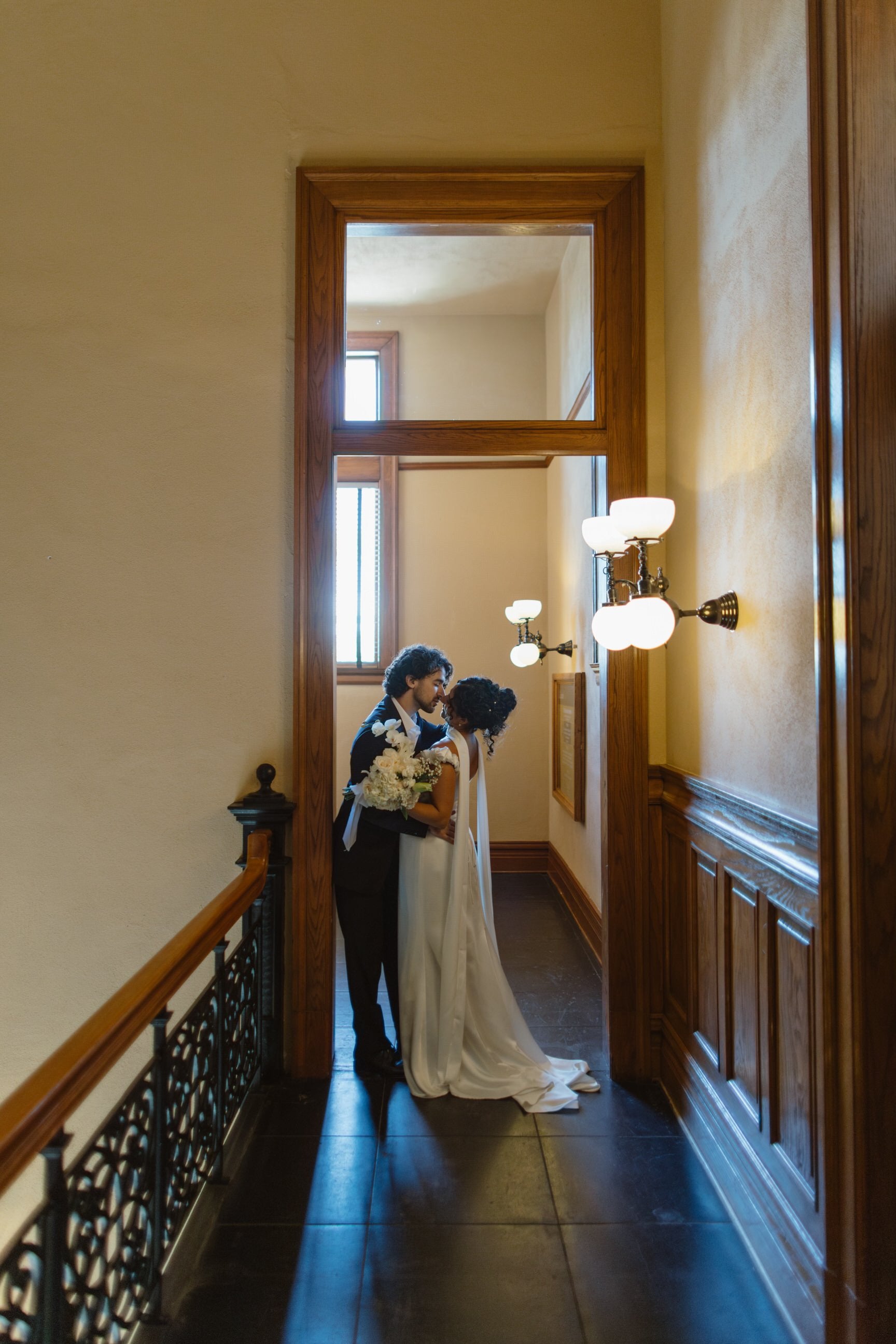 long floor length wedding scarf on bride embracing fiancé