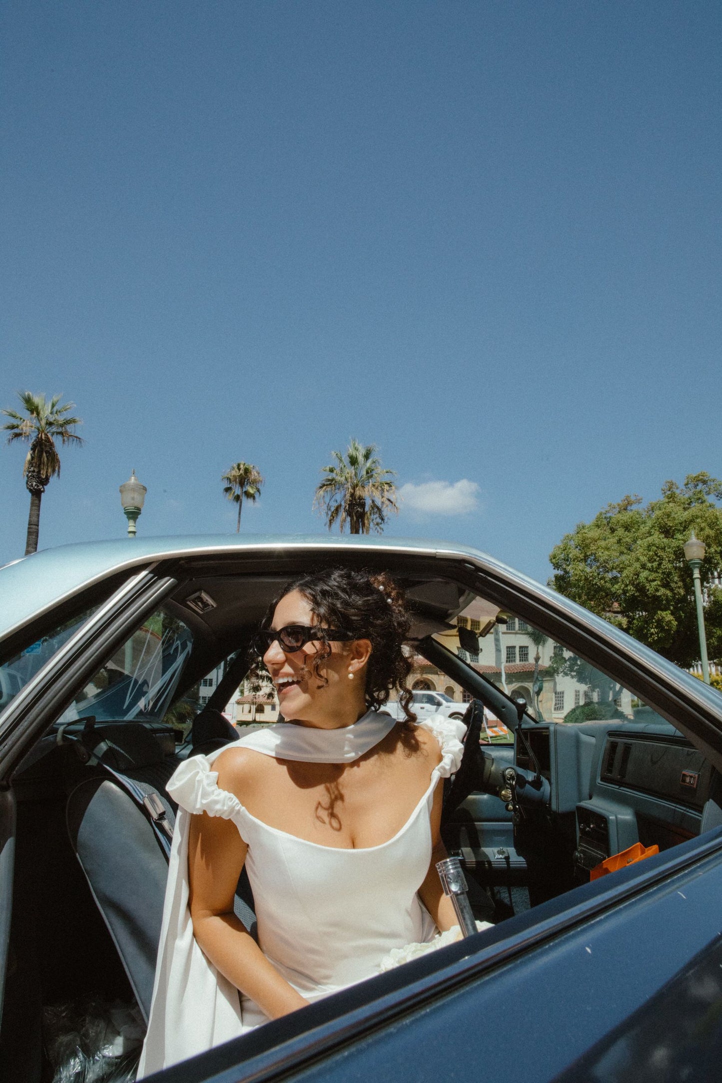 curly bridal updo with silk satin ivory wedding scarf around neck