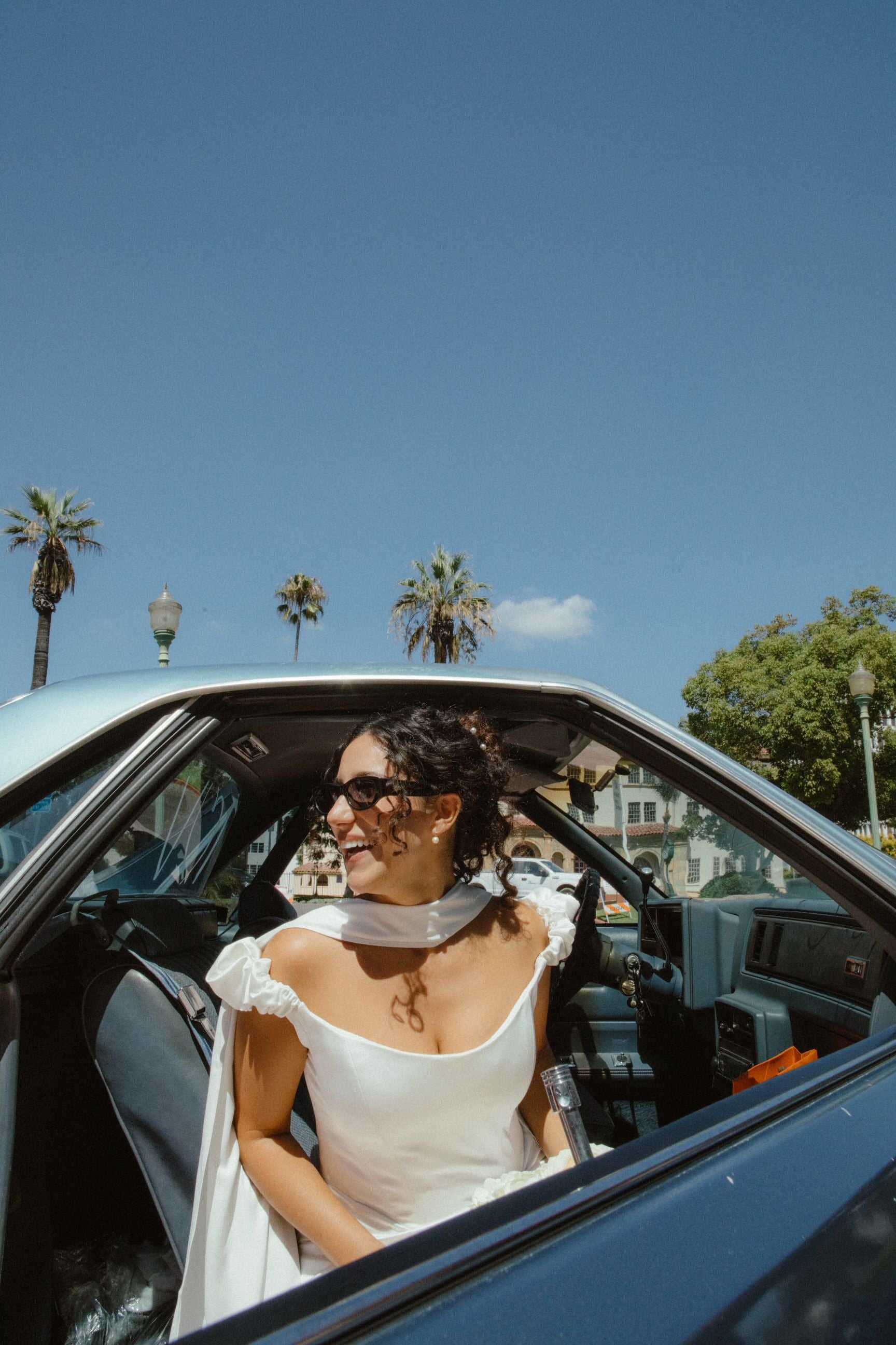 curly bridal updo with silk satin ivory wedding scarf around neck