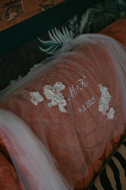 Decorative pillow at San Diego hotel with embroidered wedding veil for unity ceremony