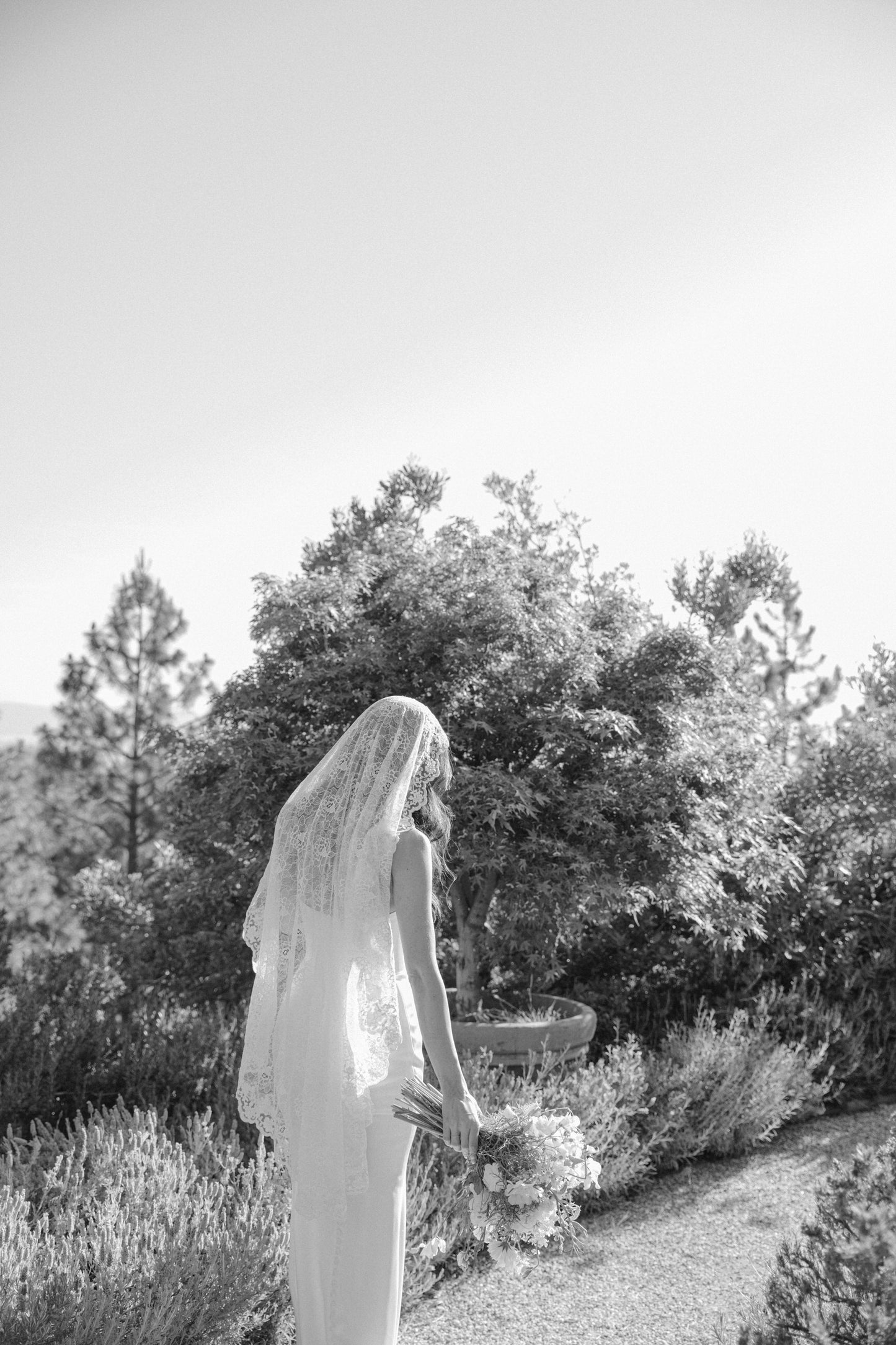 wearing a lace mantilla bridal veil on top of head in traditional spanish style