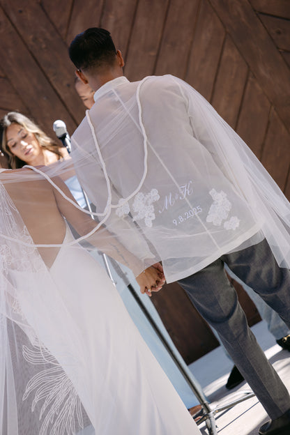 Couple wearing a white embroidered unity veil with personalized wedding date and lace applique